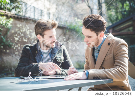 two young handsome fashion model businessmen using tablet two young handsome fashion model businessmen using tablet 10526048