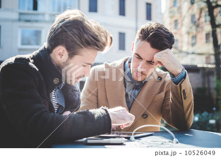 two young handsome fashion model businessmen using tablet 10526049