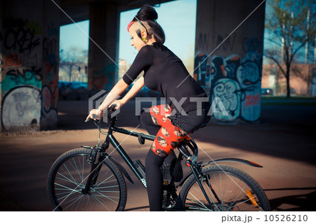 young beautiful punk dark girl riding bike 10526210