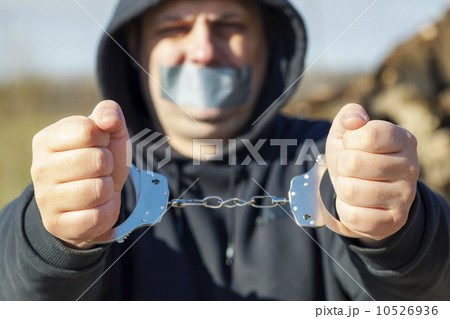 Handcuffs on hands stretched forward Handcuffs on hands stretched forward 10526936