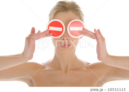 Woman holds two prohibiting signs before eyes Woman holds two prohibiting signs before eyes 10531115
