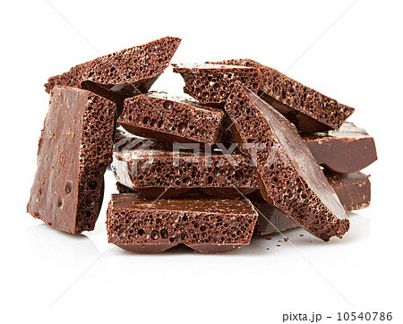 Closeup detail of chocolate parts on white background. 10540786