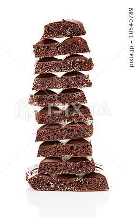 Closeup detail of chocolate parts on white background. 10540789