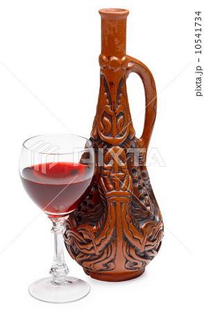 Ancient Georgian bottle and glass of wine on white background 10541734