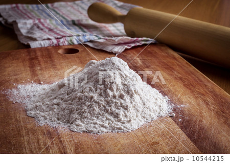 Flour, rolling pin and a towel on the table 10544215