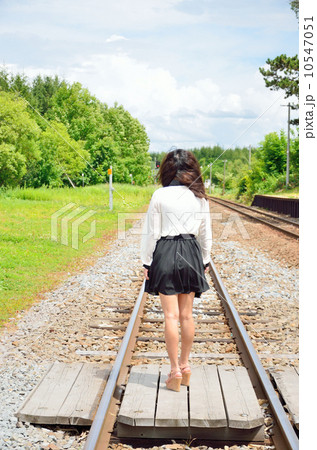 踏切に立つ若い女性の写真素材