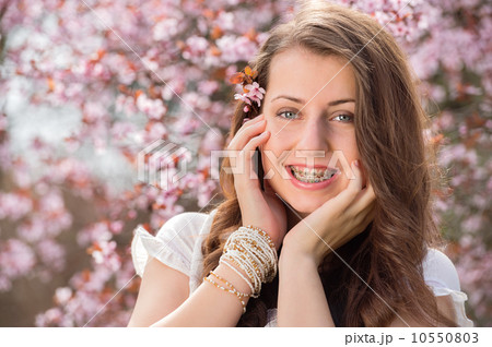 Romantic girl with braces near blossoming tree Romantic girl with braces near blossoming tree 10550803
