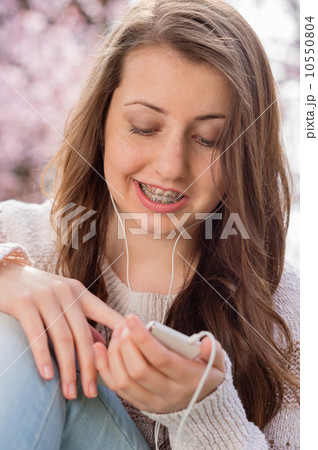 Student with braces listening to music 10550804