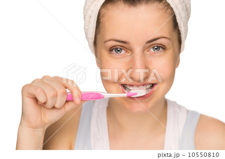 Girl with braces brushing teeth isolated 10550810