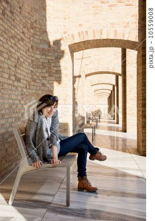 Pretty woman posing on a bench Pretty woman posing on a bench 10559008