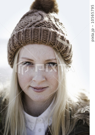 A young girl in a bobble hat on the beach. A young girl in a bobble hat on the beach. 10565795