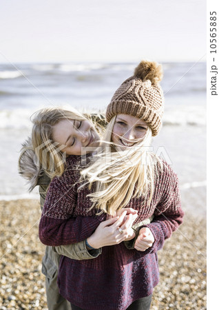 Two girls on the beach in winter. 10565885