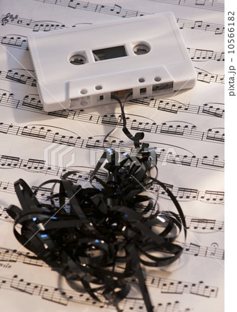White mix tape on sheet music, studio shot 10566182