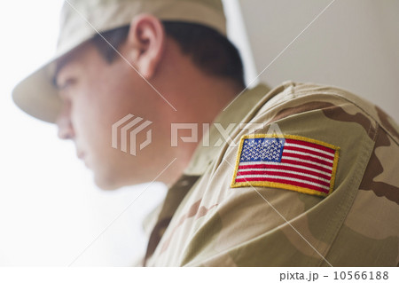 Man wearing military uniform looking through window Man wearing military uniform looking through window 10566188