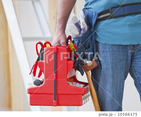 Close up of construction worker carrying tool box Close up of construction worker carrying tool box 10566375