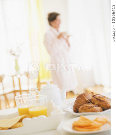 Woman in white robe drinking tea 10566415