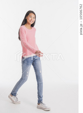 Portrait of teenage girl ( 16-17 years) walking 10566762