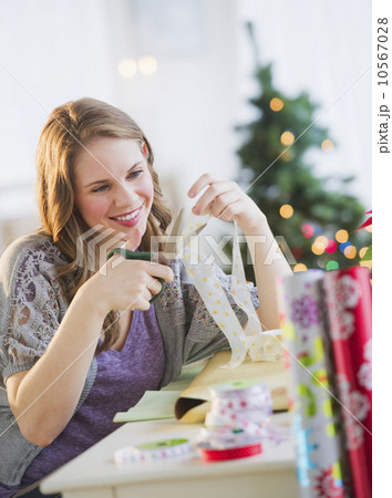 Portrait of young woman wrapping Christmas gifts 10567028