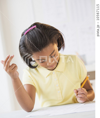 Girl (6-7) doing homework 10567115