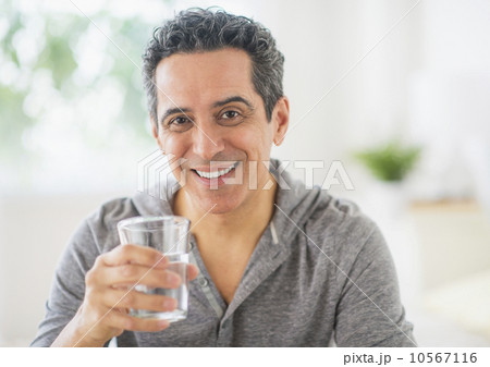 Portrait of mature man holding glass of water 10567116