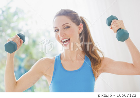 Portrait of young woman with dumbbells 10567122