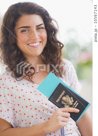 Portrait of smiling woman with passport 10567143