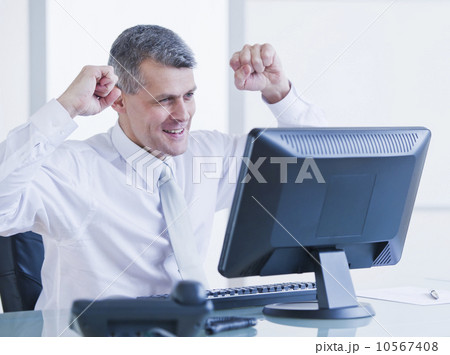 Portrait of happy businessman working at desk 10567408