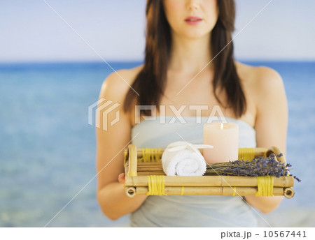 Young woman carrying tray with spa equipment, studio shot Young woman carrying tray with spa equipment, studio shot 10567441