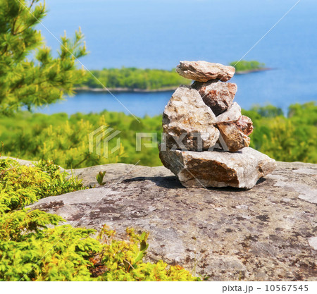USA, Maine, Camden, Pile of stones and scenic coastline  10567545