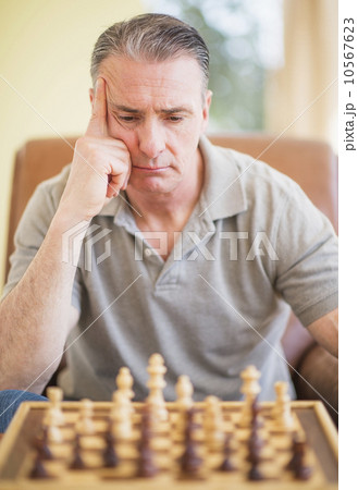 Portrait of man concentrating during chess game Portrait of man concentrating during chess game 10567623