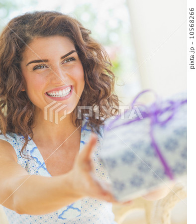 Smiling woman giving present Smiling woman giving present 10568266