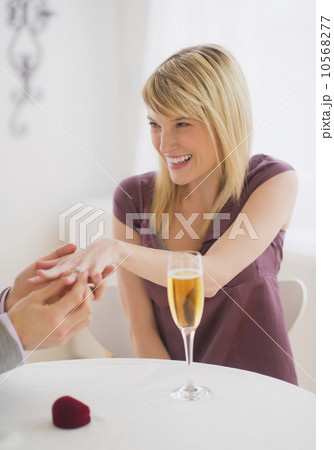 Couple celebrating engagement in restaurant Couple celebrating engagement in restaurant 10568277