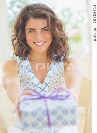 Smiling woman giving present 10568313