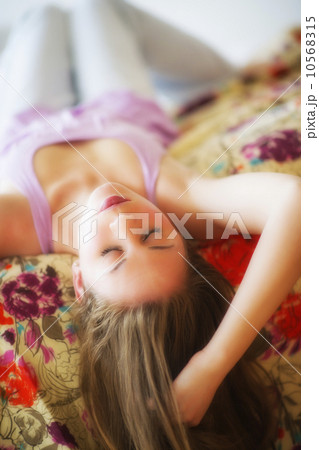 Young attractive woman lying on bed Young attractive woman lying on bed 10568315