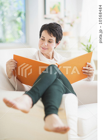 Portrait of mature woman looking at photo album Portrait of mature woman looking at photo album 10568484