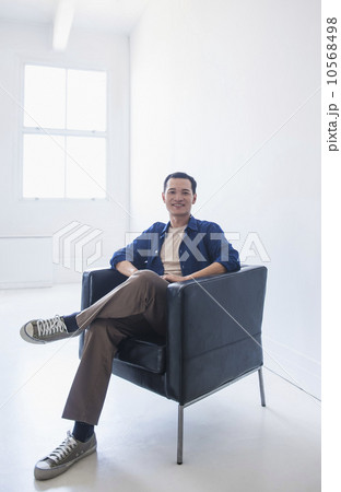 Happy mid adult man sitting in his armchair 10568498