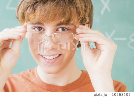 Teenage boy (14-15) in classroom wearing glasses Teenage boy (14-15) in classroom wearing glasses 10568503
