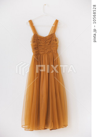 Shiffon dress on hanger against white wall Shiffon dress on hanger against white wall 10568528