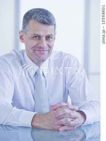 Portrait of businessman sitting at desk Portrait of businessman sitting at desk 10568601