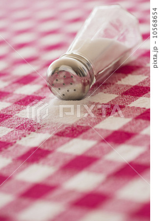 Salt shaker on checked tablecloth 10568654