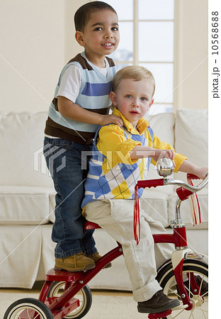 Two children on a tricycle 10568688