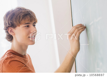 Teenage boy (14-15) in classroom 10568697