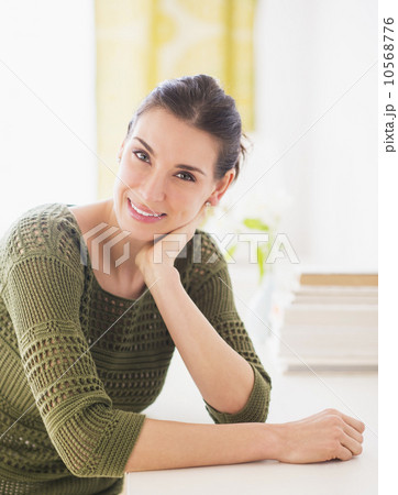 Portrait of happy woman sitting at table 10568776