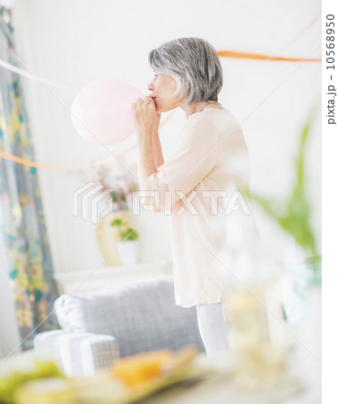 Portrait of woman blowing balloon 10568950