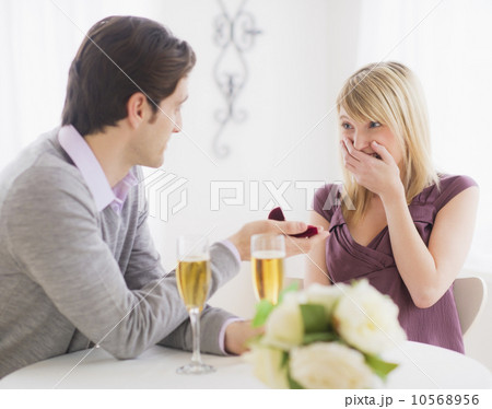 Couple celebrating engagement in restaurant 10568956