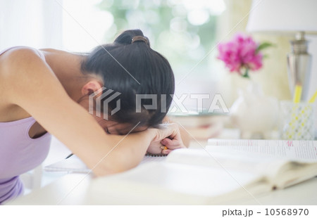 Side view of teenage girl ( 16-17 years ) with her head on table Side view of teenage girl ( 16-17 years ) with her head on table 10568970