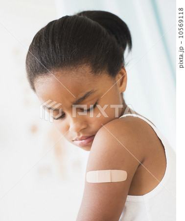 Girl (6-7) with band-aid on arm Girl (6-7) with band-aid on arm 10569118