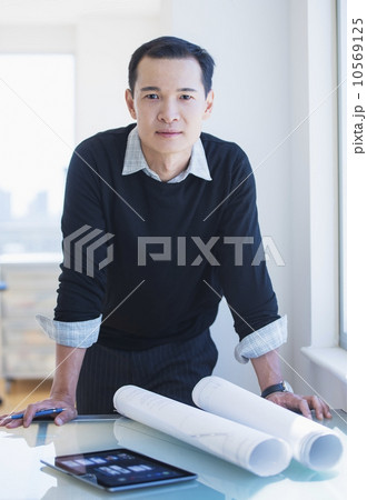 Mid adult architect working in his studio 10569125