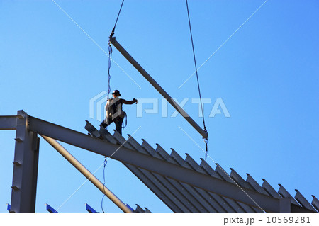 Construction worker standing on roof framing 10569281