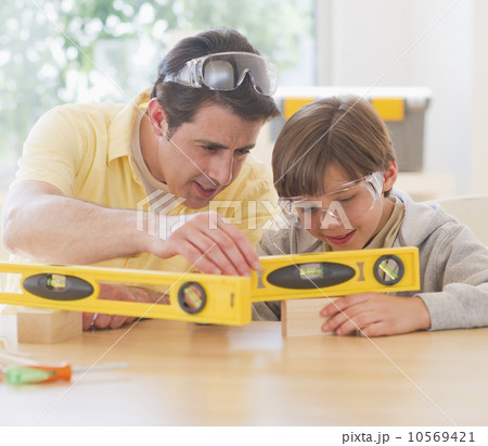 Father and son (10-11 years) using levels Father and son (10-11 years) using levels 10569421